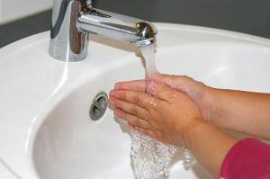 child washes their hands with softened water